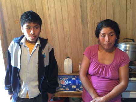 young man standing next to his mother