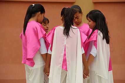 group of girls holding hands and praying