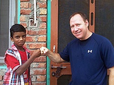Derek Gordon giving young boy a fist bump