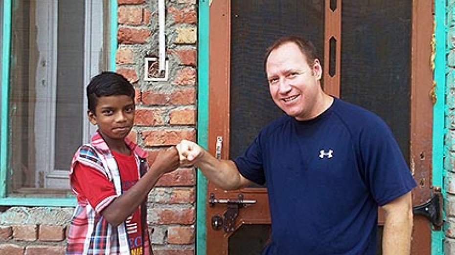 Derek Gordon giving young boy a fist bump