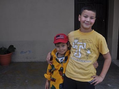 two Honduran boys with arms around each other