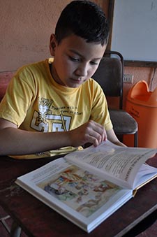 young boy reading the Bible