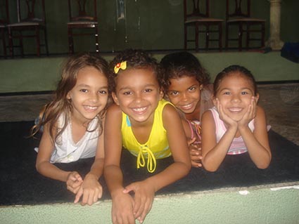 four smiling girls posing for photo