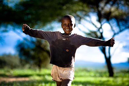 child smiling with outstretched arms