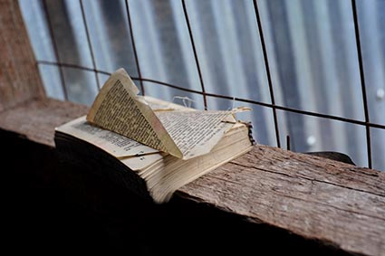 worn Bible without cover on a windowsill