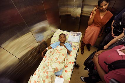 boy in hospital bed in elevator
