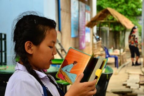 Young girl reading a bible.