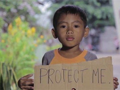 boy holding a sign