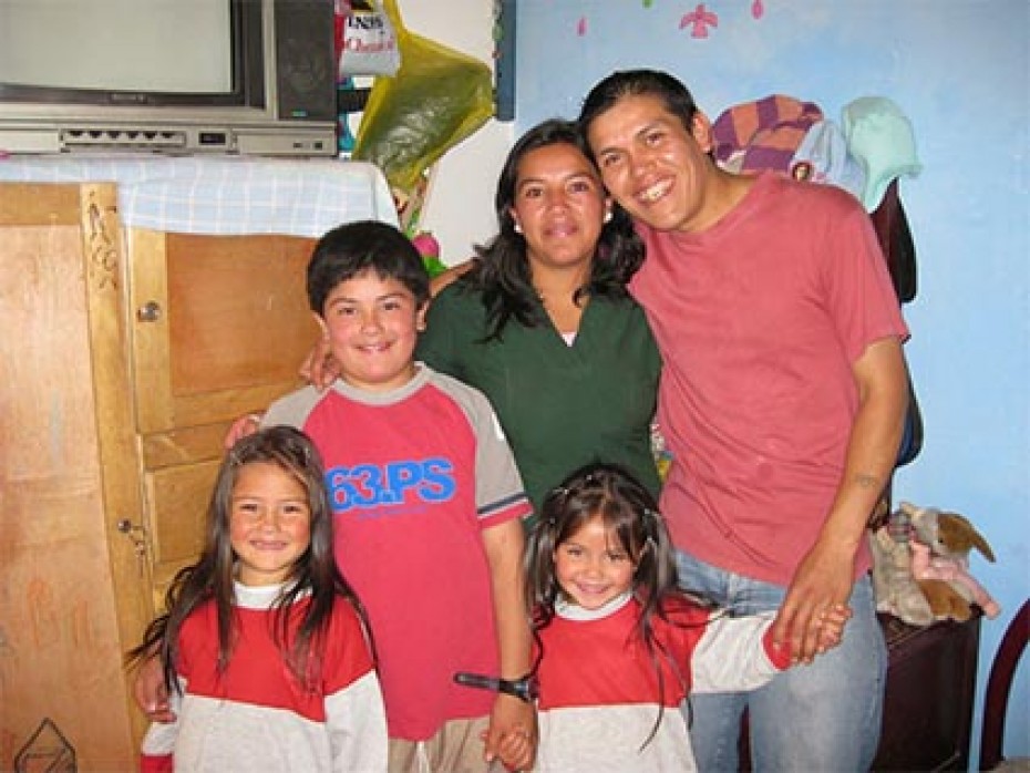 man and woman posing with three children