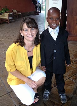 smiling young man standing next to kneeling young woman