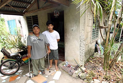 man on crutches standing next to young man