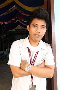 young man with arms folded across his chest