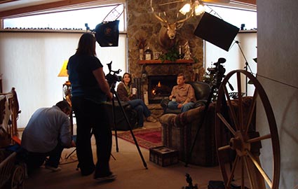 dinah and wess being photographed next to fireplace