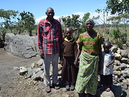 elderly man and woman standing with boy and girl