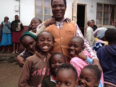man embracing group of children