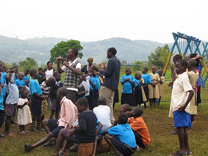 A group of people gathered by a swing set