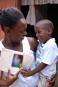 woman holding a boy and smiling