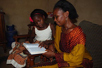 a woman and girl reading