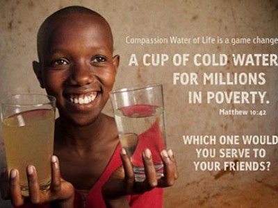 A poster with a child holding a glass of clean water and a glass of dirty water