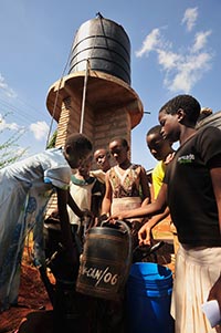 group of people filling containers with water