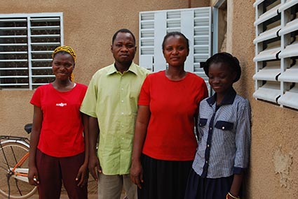 a man and three women standing outside of a building