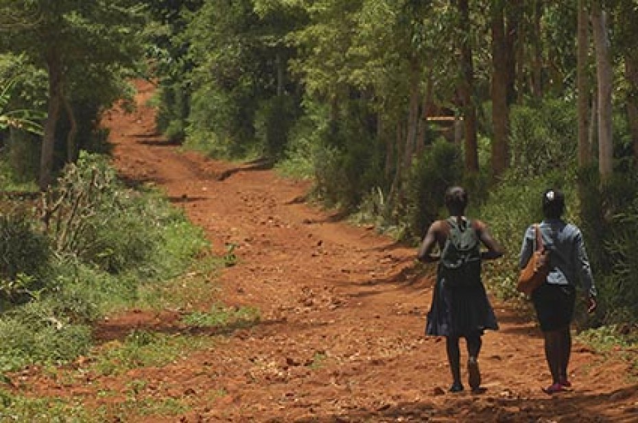 two girls walking down a dirt road