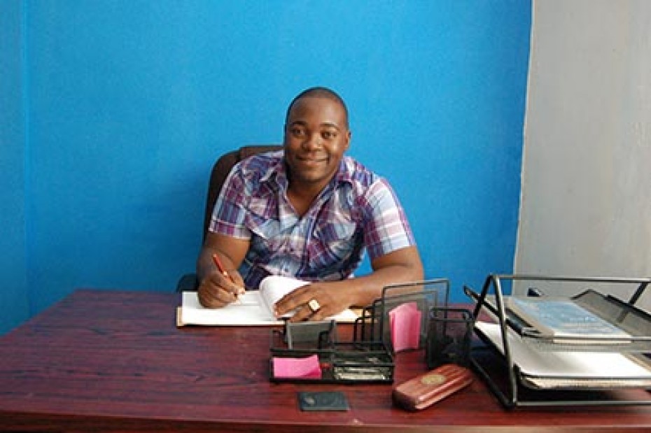 man sitting at desk writing