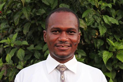 smiling man wearing white shirt and tie