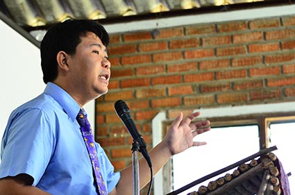 man standing at podium speaking