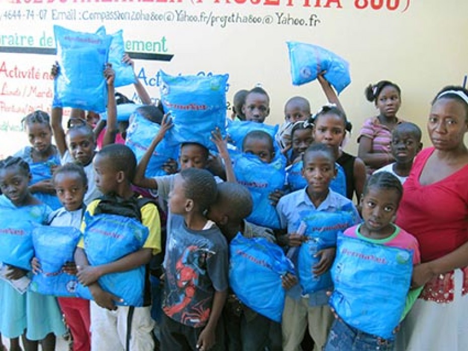 group of children holding malaria nets