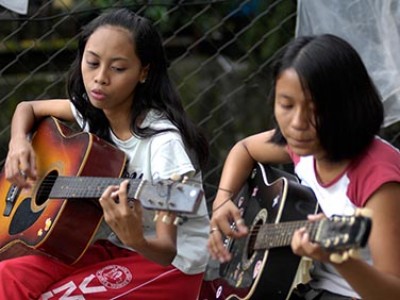 Two girls playing guitars