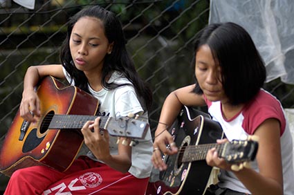 Two girls playing guitars