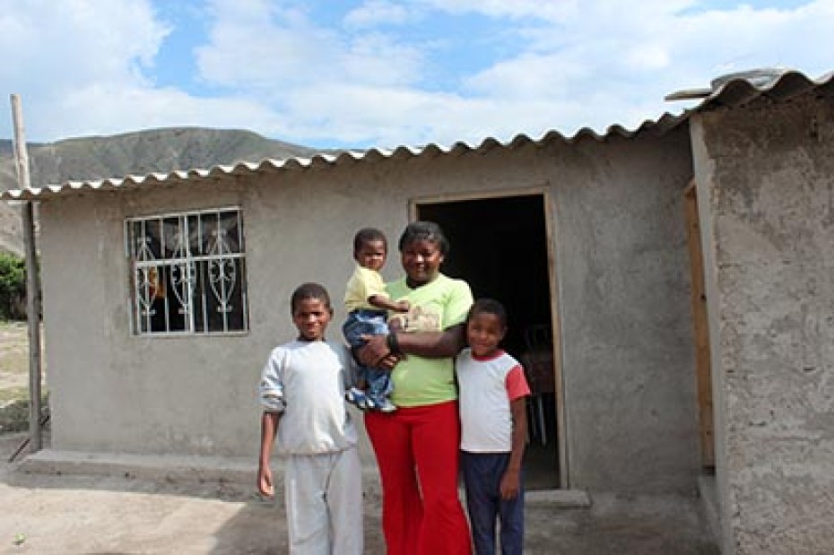 woman with children standing outside house