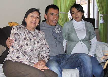 young man sitting between two women