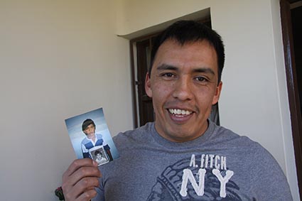 young man holding up a photo