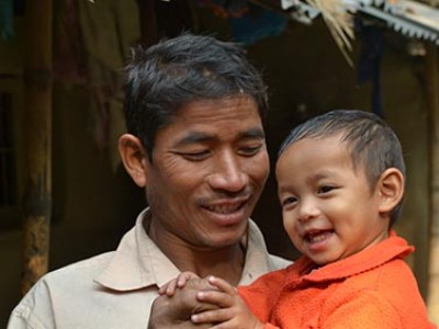 man holding smiling baby