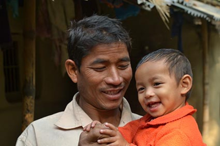 man holding smiling baby