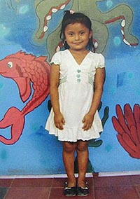smiling girl standing in front of mural