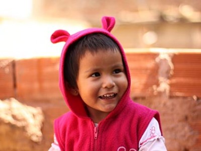 young child wearing pink hooded jacket