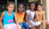 four smiling girls sitting