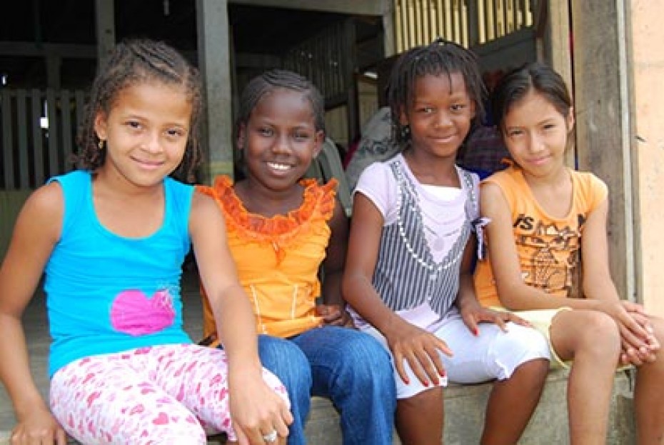 four smiling girls sitting