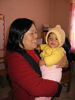 smiling woman holding baby