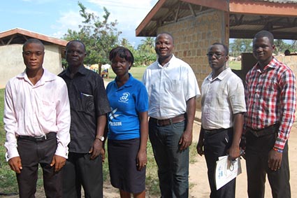 group of five men and one woman posing for photo