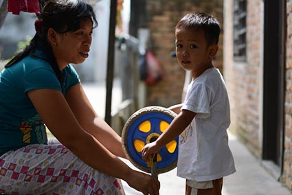 woman and boy holding a toy