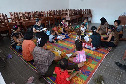 moms and babies sitting on rug