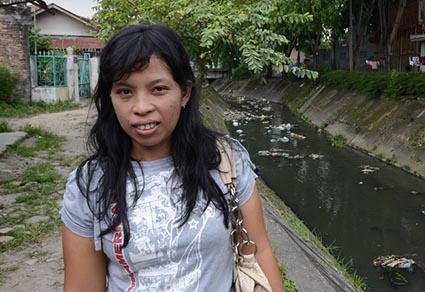 girl standing next to drainage ditch