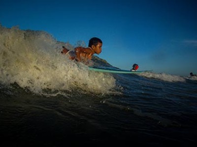 young boy on a surfboard