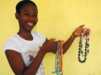 young woman holding handmade jewelry