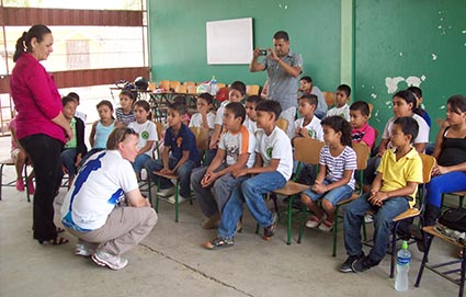 Children in a classroom with two teachers.