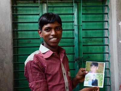 young man holding photos
